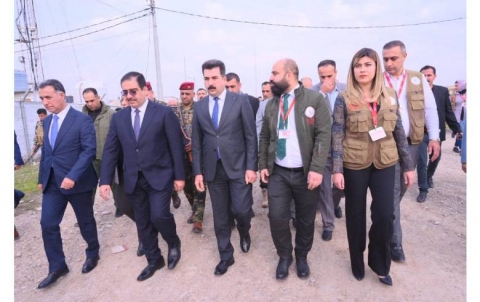 The Iraqi Ministry of Trade distributes food baskets to refugees in camps according to food receipts